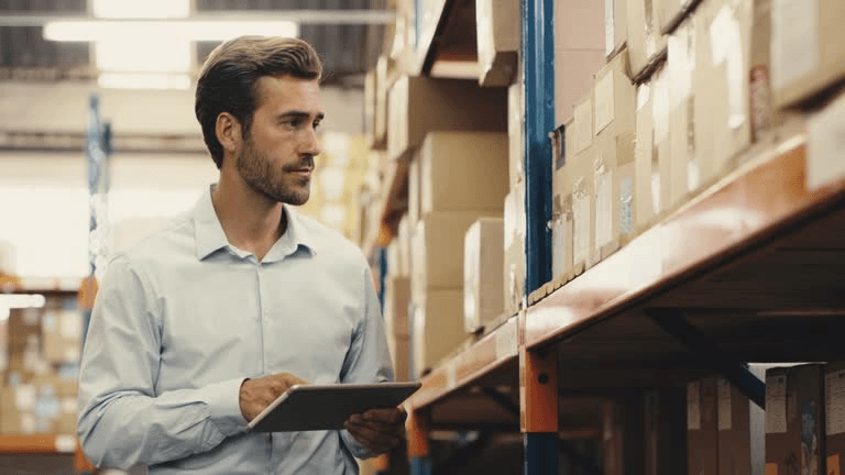 Warehouse worker checking inventory with a tablet